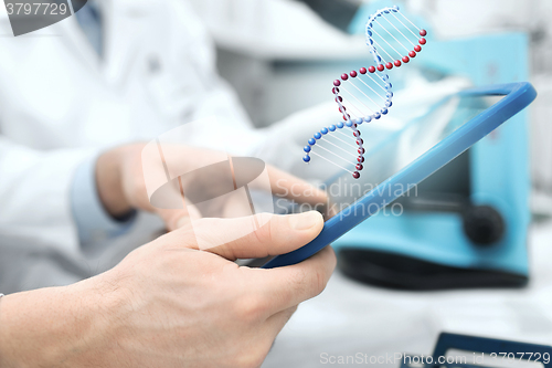 Image of close up of scientists hands with tablet pc in lab