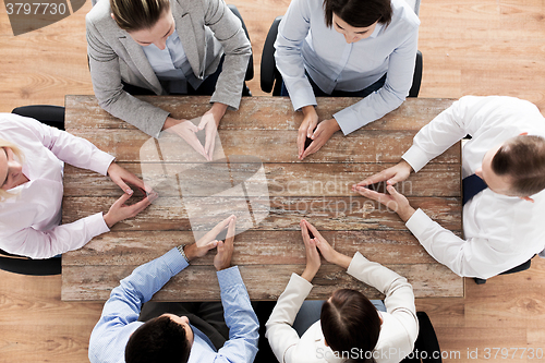 Image of close up of business team sitting at table