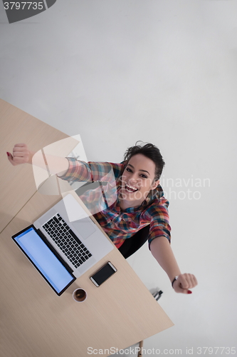 Image of top view of young business woman working on laptop