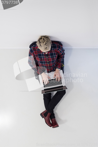Image of top view of young business woman working on laptop computer
