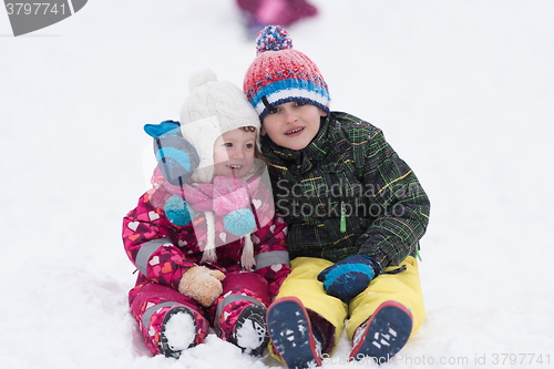 Image of group of kids having fun and play together in fresh snow