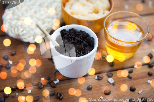 Image of close up of coffee scrub in cup and honey on wood