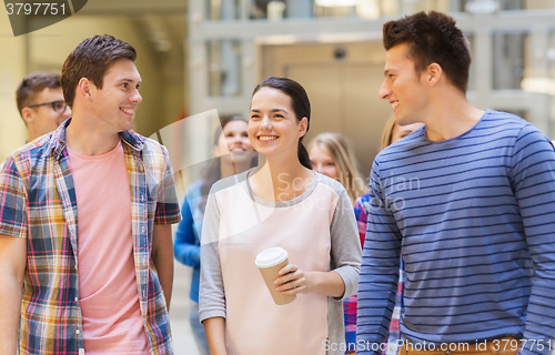 Image of group of smiling students with paper coffee cups