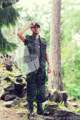 Image of young soldier or ranger in forest