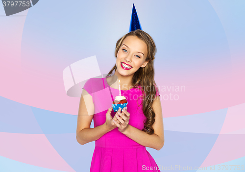 Image of happy woman or teen girl with birthday cupcake