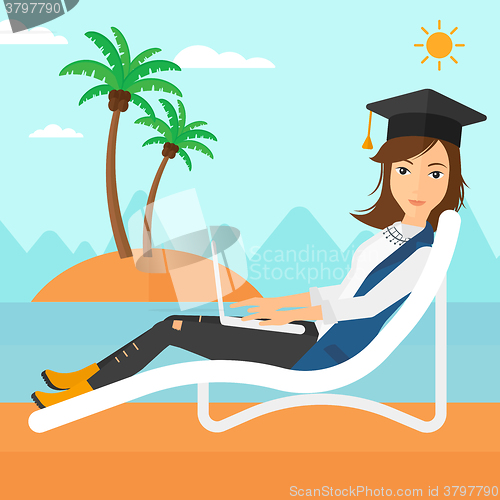 Image of Graduate lying on chaise lounge with laptop.