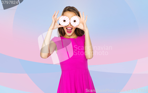 Image of happy woman or teen girl looking through donuts