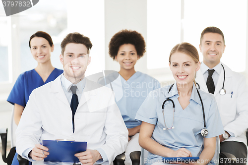 Image of group of happy doctors on seminar at hospital