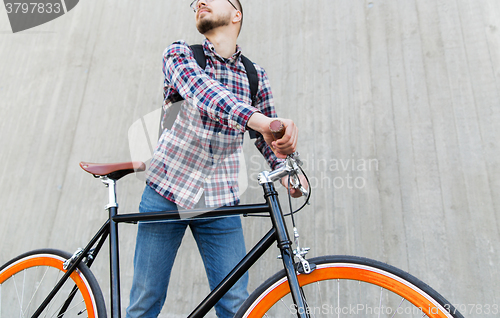 Image of hipster man with fixed gear bike and backpack