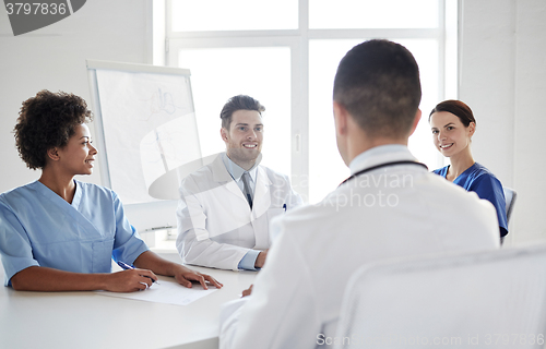 Image of group of happy doctors meeting at hospital office