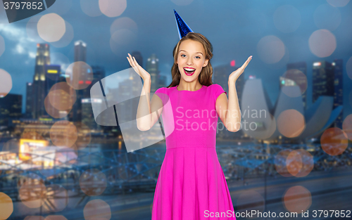 Image of happy young woman or teen girl in party cap