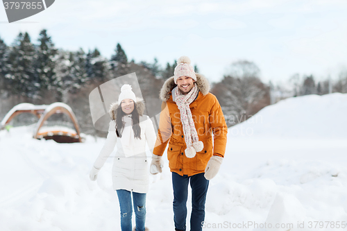 Image of happy couple walking over winter background