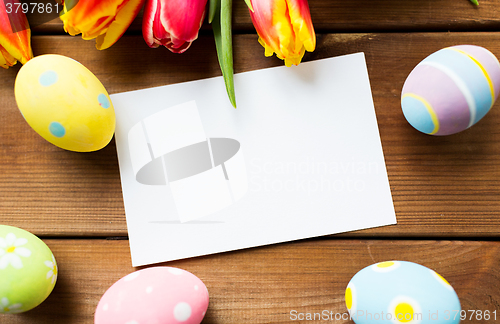 Image of close up of easter eggs, flowers and white paper