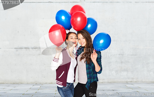 Image of happy teenage girls with helium balloons