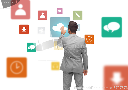 Image of businessman with virtual projection of media icons