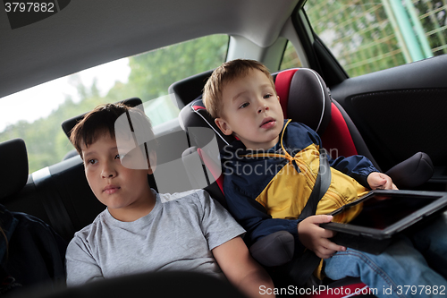 Image of Children sitting in the car and looking at road