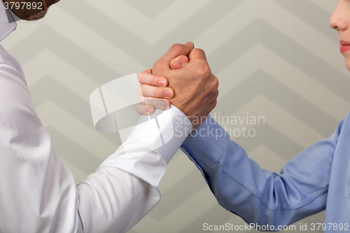 Image of Strong handshake of father and son