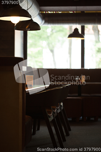 Image of Empty cafe interior with wooden furniture and sofa