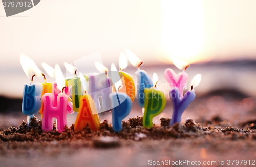 Image of Birthday candles burning on a seashore