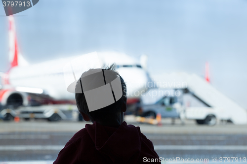 Image of Little boy watching planes at the airport