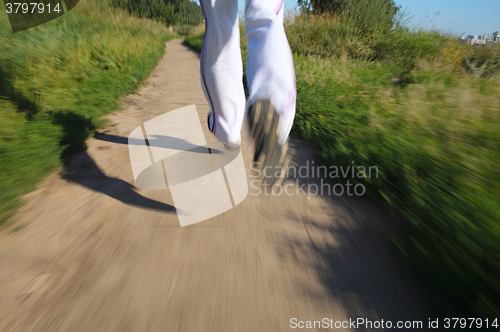 Image of Running in the park. Detail of legs