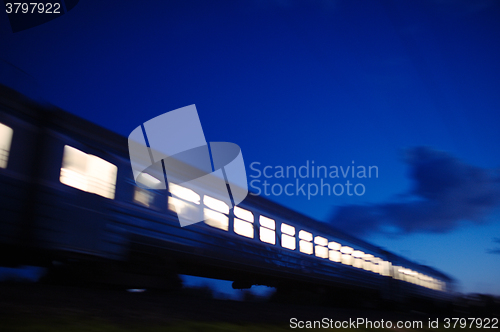 Image of Illuminated train traveling past at night