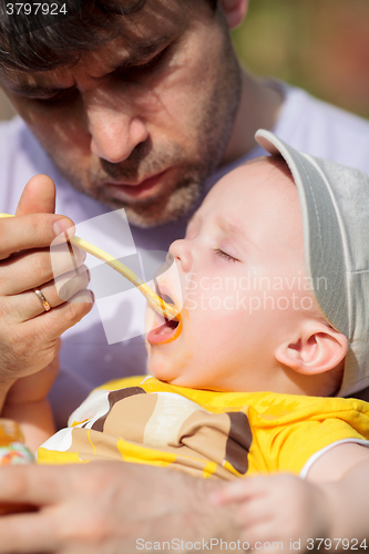 Image of Daddy feeding toddler