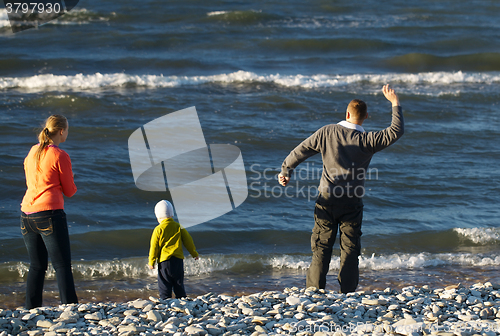 Image of Family of three on pebble beach