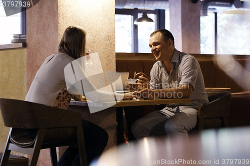 Image of Young couple in a cafe