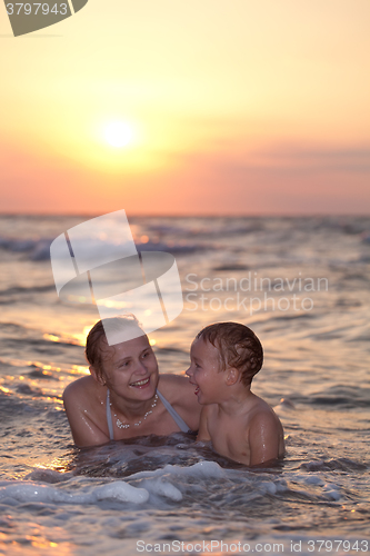 Image of Mother enjoying an evening swim with her son