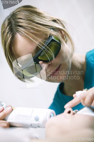 Image of Doctor doing a fractional skin laser treatment