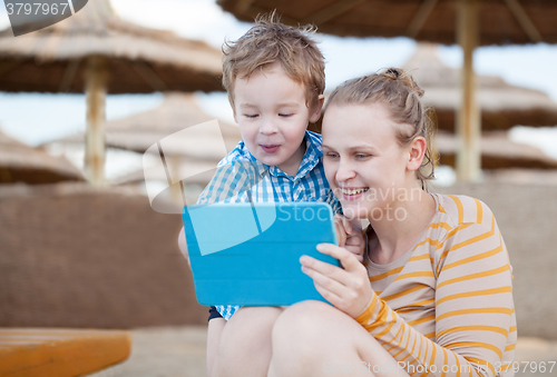 Image of Happy mother and son at a beach resort