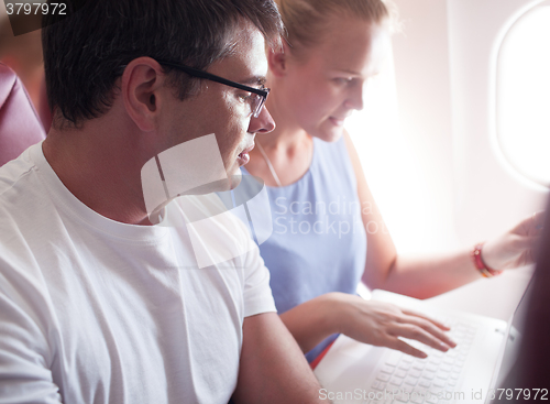 Image of People with Laptop on a Plane