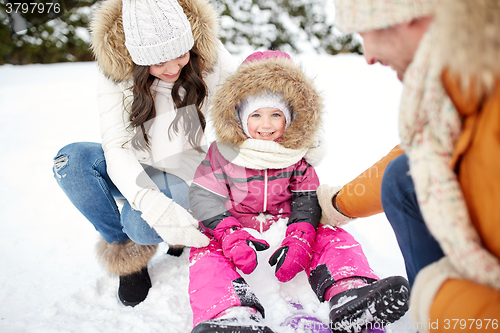 Image of happy family with sled walking in winter outdoors