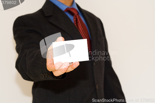 Image of business man holding a white card