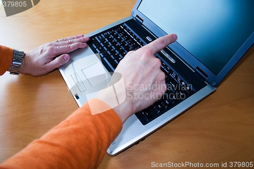 Image of Young pointing to laptop