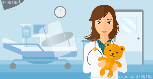 Image of Pediatrician holding teddy bear.