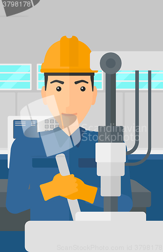 Image of Man working with industrial equipment.