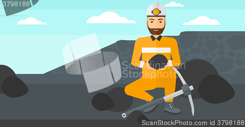 Image of Miner holding coal in hands.