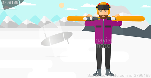 Image of Man holding skis.