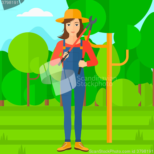 Image of Farmer with pruner in garden.