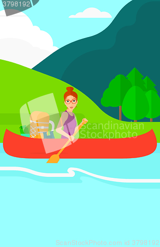 Image of Woman canoeing on the river.