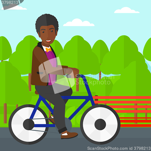 Image of Man riding bicycle.