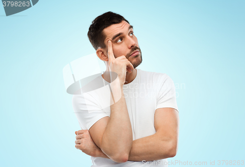 Image of man thinking over blue background