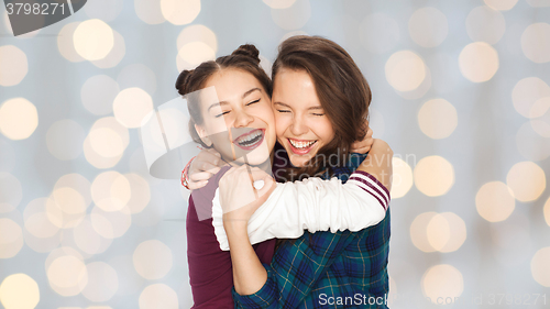 Image of happy smiling pretty teenage girls hugging