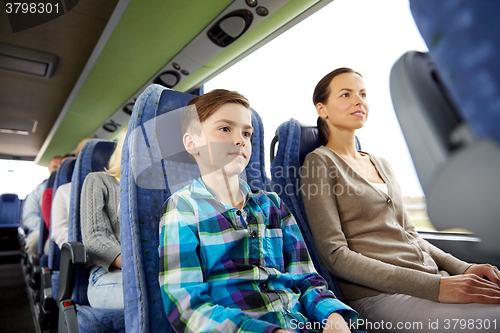 Image of happy family riding in travel bus