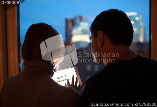 Image of Couple Using Tablet PC in the Evening