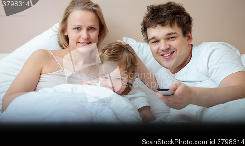 Image of Happy family watching television