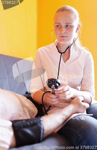 Image of Nurse measures the patient blood pressure