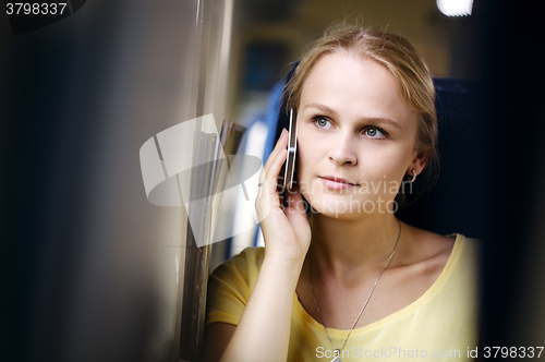 Image of Woman listening to a call on her mobile